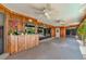 Spacious screened porch with wood-paneled walls, ceiling fans, and tile flooring at 225 Brighton Ct, Englewood, FL 34223