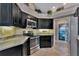 Stylish kitchen boasting dark wood cabinets and granite countertops at 225 Brighton Ct, Englewood, FL 34223