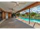Screened pool area with ceiling fans and wood paneling at 225 Brighton Ct, Englewood, FL 34223