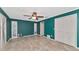 Bedroom with teal walls, tile flooring, and built-in closet at 225 Brighton Ct, Englewood, FL 34223