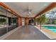 Screened pool area with ceiling fans and wood paneling at 225 Brighton Ct, Englewood, FL 34223