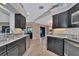 Spacious kitchen with dark cabinetry and granite countertops at 225 Brighton Ct, Englewood, FL 34223
