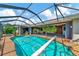 Relaxing pool and spa area with screened enclosure and lush landscaping at 225 Brighton Ct, Englewood, FL 34223