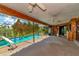 Screened pool area with ceiling fans and wood paneling at 225 Brighton Ct, Englewood, FL 34223