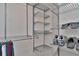 Well-organized walk-in closet featuring custom shelving at 225 Brighton Ct, Englewood, FL 34223