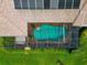Enclosed kidney-shaped pool with solar panels on the roof at 225 Brighton Ct, Englewood, FL 34223