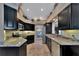 Modern kitchen with dark cabinetry, granite counters, and stainless steel appliances at 225 Brighton Ct, Englewood, FL 34223