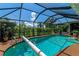 Inviting screened pool with diving board and large deck at 225 Brighton Ct, Englewood, FL 34223