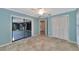 Bedroom with light blue walls, tile floors, and access to patio at 225 Brighton Ct, Englewood, FL 34223