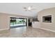 Bright living room with tile floors, sliding glass doors opening to the pool, and a pass-through bar at 225 Brighton Ct, Englewood, FL 34223