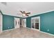 Bedroom featuring teal walls, tile floors, and access to exterior at 225 Brighton Ct, Englewood, FL 34223