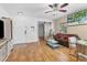 Living room with hardwood floors, a ceiling fan, and a view into the kitchen at 2534 29Th E Ave, Palmetto, FL 34221