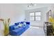 Relaxing living room with blue sofa and large window at 15533 White Linen Dr, Lakewood Ranch, FL 34211