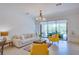 Living room with off-white couch and yellow accent chairs at 15533 White Linen Dr, Lakewood Ranch, FL 34211