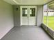 Screened porch with double doors leading to backyard at 5278 Sabrina Ter, North Port, FL 34286