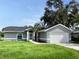 Newly constructed home with gray exterior, a two-car garage, and a well-manicured lawn at 5278 Sabrina Ter, North Port, FL 34286