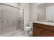 Bathroom with a large shower, granite countertop, and wood cabinets at 6927 Dorset Ct, Bradenton, FL 34202