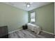 Small bedroom with twin bed, light green walls at 6622 Devesta Loop, Palmetto, FL 34221