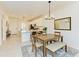 Open concept dining area with a wood table and bench seating at 18114 Gawthrop Dr # 403, Bradenton, FL 34211