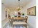 Spacious dining area with a wooden table and bench seating, adjacent to the kitchen at 18114 Gawthrop Dr # 403, Bradenton, FL 34211