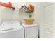 Bright laundry room with washer, dryer, and shelving at 18114 Gawthrop Dr # 403, Bradenton, FL 34211