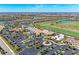 Aerial view of a country club community, showing the clubhouse, pool, and golf course at 18114 Gawthrop Dr # 403, Bradenton, FL 34211