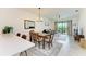 Bright dining area with wood table, chairs, and access to living room at 18114 Gawthrop Dr # 403, Bradenton, FL 34211
