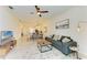 Open living room with grey sofa and views into the kitchen and dining areas at 18114 Gawthrop Dr # 403, Bradenton, FL 34211