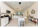 Modern kitchen with white cabinets and island at 18114 Gawthrop Dr # 403, Bradenton, FL 34211