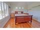 Bright bedroom with hardwood floors and plantation shutters at 702 Treasure Boat Way, Sarasota, FL 34242