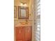 Powder room with glass vessel sink and wood vanity at 702 Treasure Boat Way, Sarasota, FL 34242