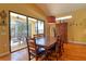 Dining area with wooden table and chairs, plus view of the pool at 702 Treasure Boat Way, Sarasota, FL 34242