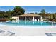 Community pool with a large patio and lounge chairs at 7106 Bright Creek Dr # 44, Sarasota, FL 34231