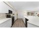 White kitchen with black appliances and tile flooring at 1326 Wesley Dr # 132, Punta Gorda, FL 33950