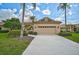 Charming single-story home with a two-car garage, tiled roof, and lush landscaping at 7157 Del Lago Dr, Sarasota, FL 34238