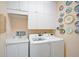 Laundry room with white cabinets, double LG washer and dryer at 7157 Del Lago Dr, Sarasota, FL 34238