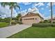 One-story home with a two-car garage and palm trees at 7157 Del Lago Dr, Sarasota, FL 34238