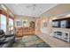 Bright living room featuring leather sofas, a large TV, and access to other rooms at 7157 Del Lago Dr, Sarasota, FL 34238