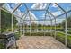 Large screened in patio with lake views and built in grill at 7157 Del Lago Dr, Sarasota, FL 34238