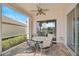 Covered patio features a table and chairs with serene lake views at 7157 Del Lago Dr, Sarasota, FL 34238