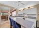 Eat-in kitchen with white cabinets, large island, and access to Gathering room at 7157 Del Lago Dr, Sarasota, FL 34238
