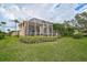 Screened patio and beautifully landscaped backyard at 7157 Del Lago Dr, Sarasota, FL 34238
