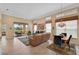 Spacious living room with leather sofas and view of the golf course at 7157 Del Lago Dr, Sarasota, FL 34238