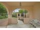 Covered porch with arched entryway and ornate bench at 7157 Del Lago Dr, Sarasota, FL 34238