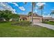 Single-story home with a two-car garage, lush landscaping at 7157 Del Lago Dr, Sarasota, FL 34238