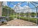 Spacious screened patio with a grill and stunning lake views at 7157 Del Lago Dr, Sarasota, FL 34238