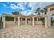 Covered patio area with tables and chairs near the pool at 7157 Del Lago Dr, Sarasota, FL 34238