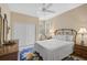 Bright bedroom with double door closet and ceiling fan at 7157 Del Lago Dr, Sarasota, FL 34238