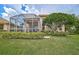 Spacious backyard with screened patio and lush landscaping at 7157 Del Lago Dr, Sarasota, FL 34238