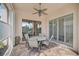 Outdoor patio with seating area and ceiling fan, overlooking a peaceful lake at 7157 Del Lago Dr, Sarasota, FL 34238
